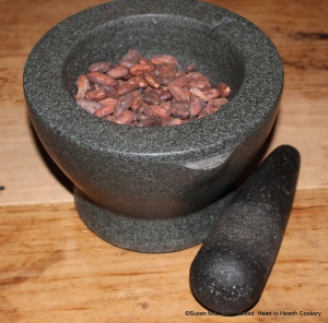 The first step in Penelope Jephson's circa 1674 manuscript receipt (recipe) To make Chocolate is to take a pound of cacao nut.  Since I am making half the receipt, there is one-half pound of fermented trinitario cacao beans in the mortar and pestle ready to be ground.