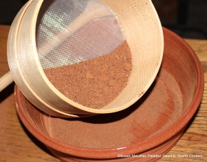 After the cacao nuts have been finely beaten in a mortar and pestle for the receipt (recipe) To make Chocolate they are searced.  The process of searcing is sieving  but typically the word sieve was the term for agricultural uses in the 17th and 18th century and the term searce was reserved for cooking.  